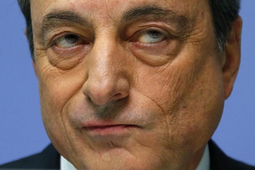 ECB president Mario Draghi addressing an ECB news conference on Dec 4, 2014. In an interview with a German paper, he warned that euro zone faces a growing risk of unstable prices. -- PHOTO: REUTERS