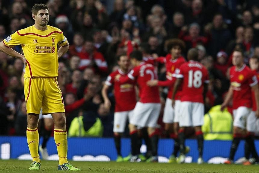 Liverpool's Steven Gerrard reacts after Manchester United's third goal during their English Premier League soccer match at Old Trafford in Manchester, northern England on Dec 14, 2014.&nbsp;Liverpool legend Steven Gerrard is set to make the shock ann