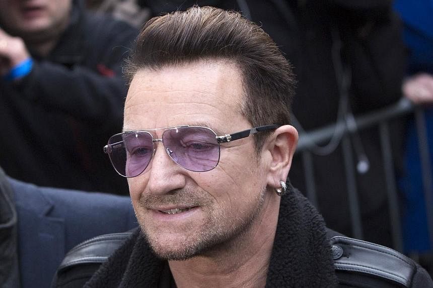 U2 lead singer Bono arrives for the recording of the Band Aid 30 charity single in west London on Nov 15, 2014. Bono has said that he may not ever play the guitar again after a cycling accident that left his severely injured. -- PHOTO: REUTERS