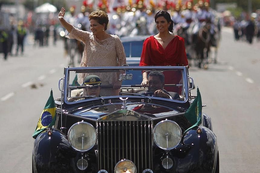 Brazil's President Dilma Rousseff (left) and daughter Paula riding towards Congress, where Ms Rousseff is to be sworn in for a second four-year term in Brasilia Jan 1, 2015. -- PHOTO: REUTERS