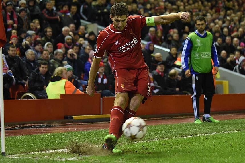 Liverpool's English midfielder Steven Gerrard takes a corner during the UEFA Champions League football match between Liverpool and Basel at Anfield in Liverpool on Dec 9, 2014. -- PHOTO: AFP&nbsp;