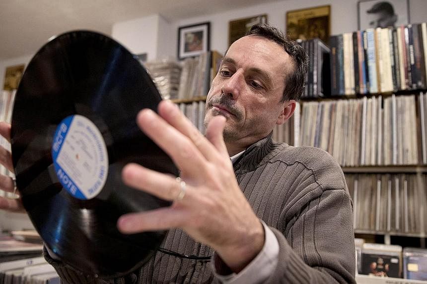 Vinyl sales and music streaming both soared by more than 50 per cent in 2014 in the United States, even as overall sales kept declining, a music industry monitor said. -- PHOTO: AFP