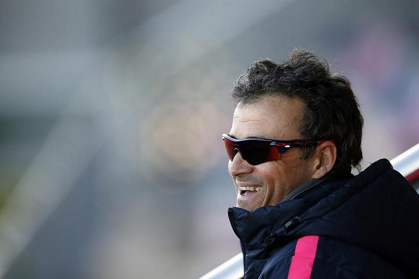Barcelona's coach Luis Enrique smiles during a training session at Joan Gamper training camp, near Barcelona Dec 19, 2014. Enrique believes the football club's transfer ban is an "invitation" for players from their famed youth academy to push for a p