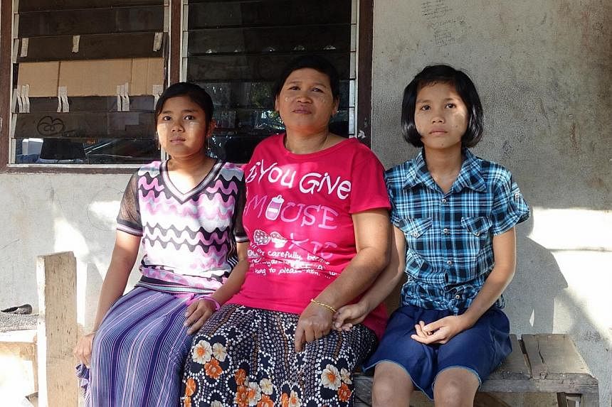 Myanmar national Than Than Htay, 47, has been working as a textile worker in Poipet for five years. Her two daughters - Nay Yee Oo, 15 and Shoon Le Yee, 12 - are forbidden from venturing out of the school and factory dormitory premises as they do not