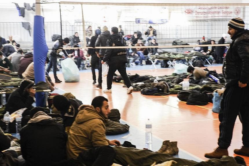 Migrants taking refuge at a first aid centre set up at the Gallipoli fitness centre, on Dec 31, 2014, after arriving in Italy aboard the Moldovan-flagged ship Blue Sky M in the port of Gallipoli, in south-eastern of Italy.&nbsp;Italian coast guards h
