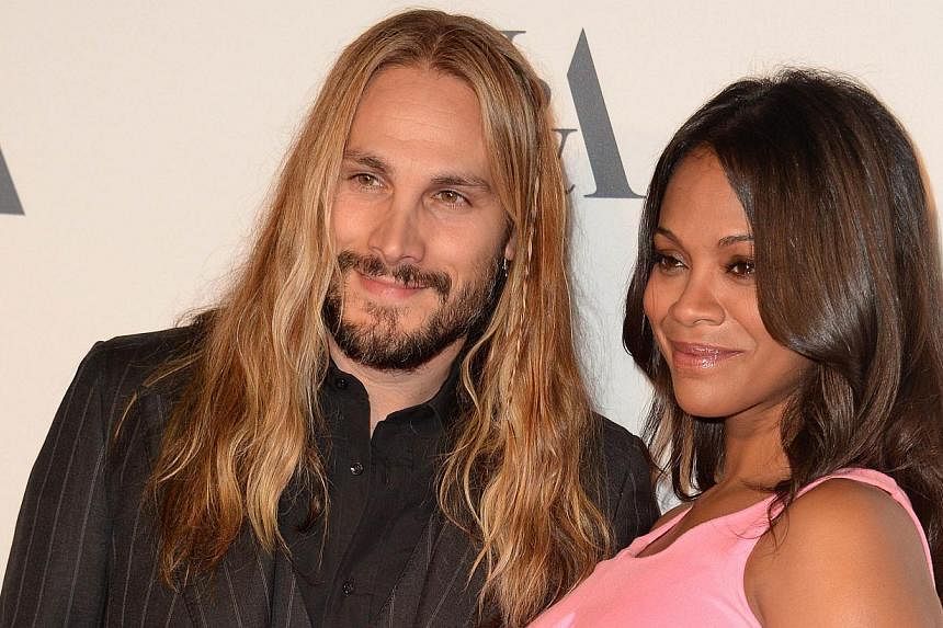 Actress Zoe Saldana and husband, Marco Perego, arrive at a cocktail reception to celebrate the opening of the multimedia exhibition "Hollywood Costume," in this Oct 1, 2014, file photo in Los Angeles.&nbsp;Saldana announced Friday she had given birth