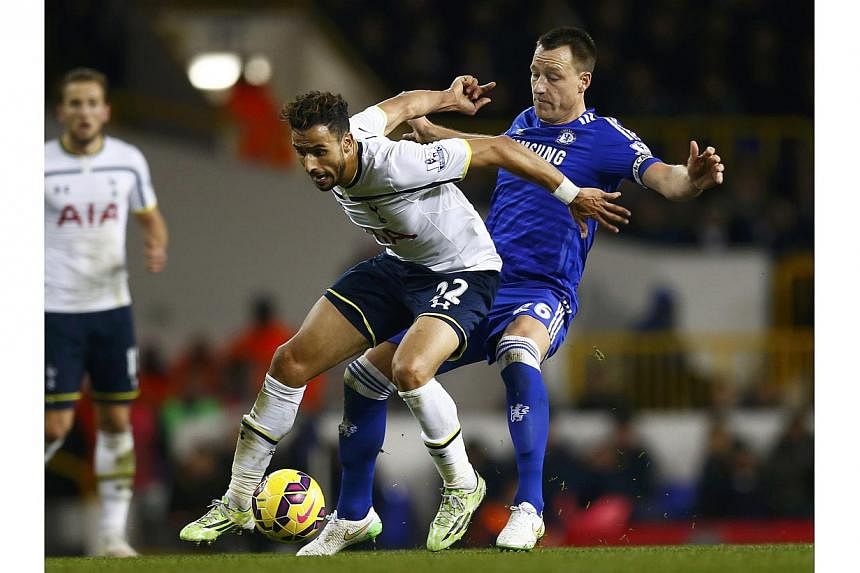 Tottenham Hotspur's Nacer Chadli is challenged by Chelsea's John Terry (right) during their English Premier League soccer match at White Hart Lane in London Jan 1, 2015. -- PHOTO: REUTERS