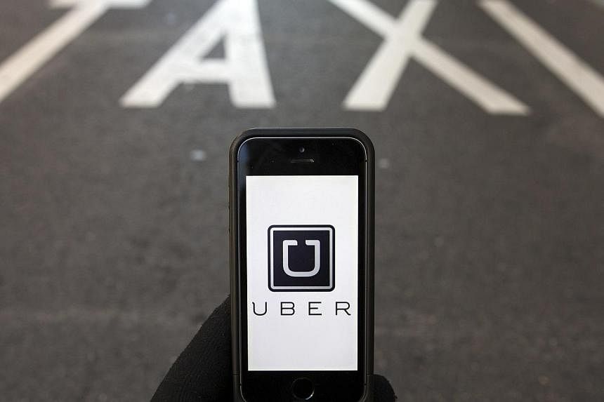 The logo of car-sharing service app Uber is seen in this photo illustration taken in Madrid on Dec 10, 2014. -- PHOTO: REUTERS &nbsp;