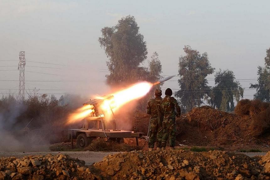 Iraqi soldiers launch a rocket during clashes against the Islamic State in Iraq and Syria (ISIS) near Dujail, some 70km north of Baghdad on Jan 2, 2015.&nbsp;Australian Prime Minister Tony Abbott visited Baghdad on Sunday, Jan 4, for talks on aiding 