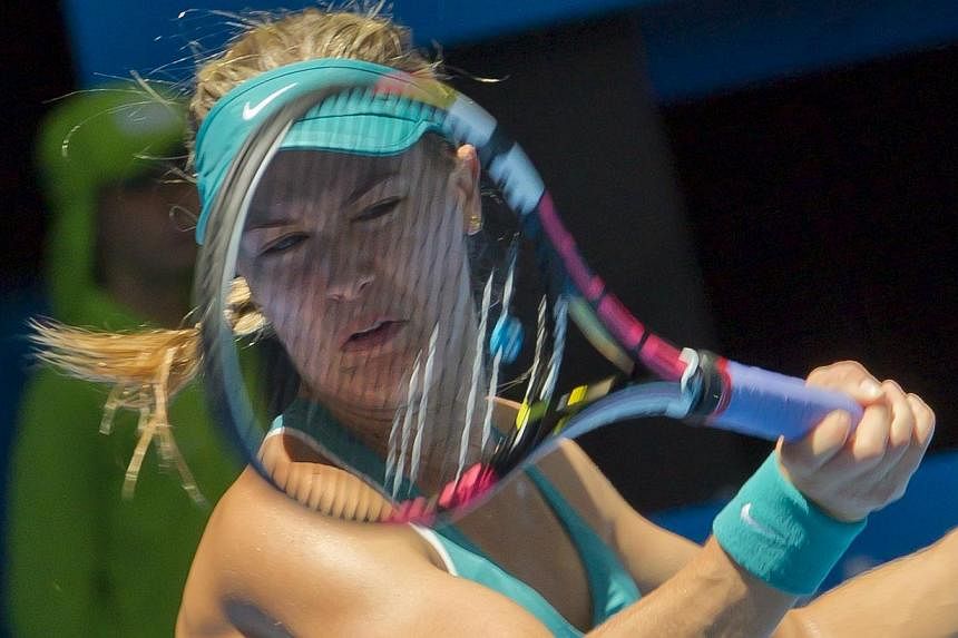 Eugenie Bouchard of Canada hits a return against Lucie Safarova of the Czech Republic during their first session women's singles match on day one of the Hopman Cup tennis tournament in Perth on Jan 4, 2015.&nbsp;-- PHOTO: AFP