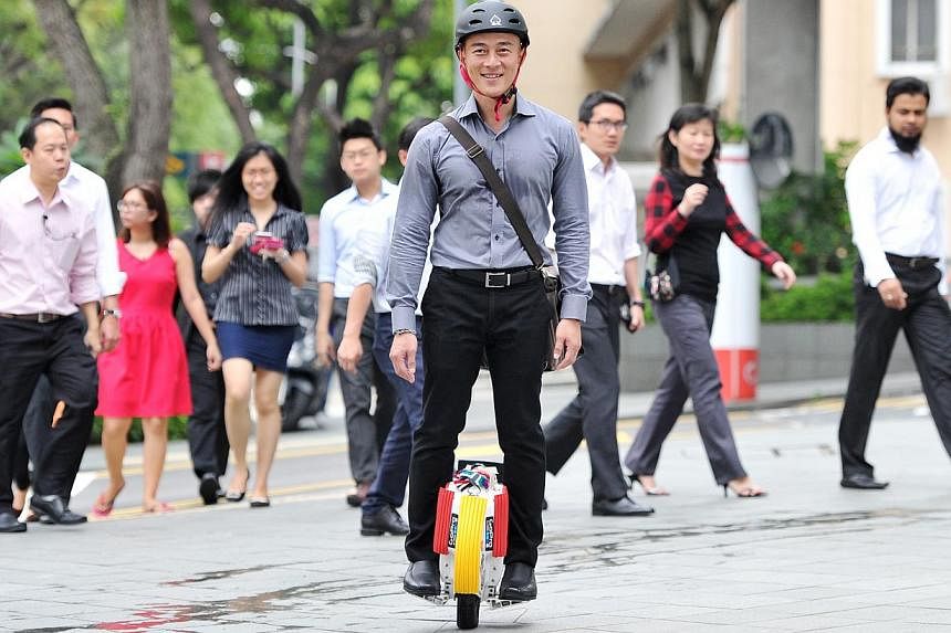 Mr Rick Tan, 43, takes 20 minutes to ride his electric unicycle from his home in Boon Keng to his office in Beach Road. -- PHOTO: LIM YAOHUI FOR THE SUNDAY TIMES
