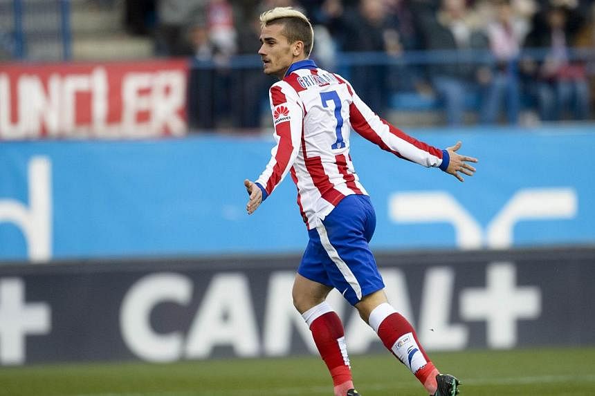 Atletico Madrid's French midfielder Antoine Griezmann celebrates his second goal during the Spanish league football match Club Atletico de Madrid versus Levante UD at the Vicente Calderon stadium in Madrid on Jan 3, 2015. -- PHOTO: AFP