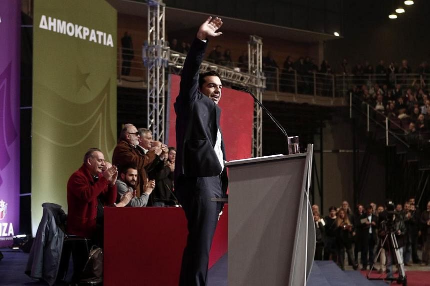 Syriza leader Alexis Tsipras waves to supporters at a party congress in Athens Jan 3, 2015.&nbsp;Greece's radical leftist Syriza party led the ruling conservatives by 3.1 percentage points in an opinion poll conducted after it became clear that a sna