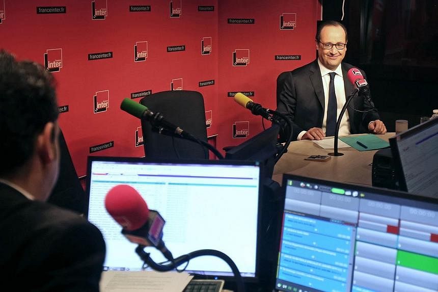 French President Francois Hollande prepares to answer journalists' questions during a live interview on French radio station France Inter on Jan 5, 2015 in Paris. -- PHOTO: AFP