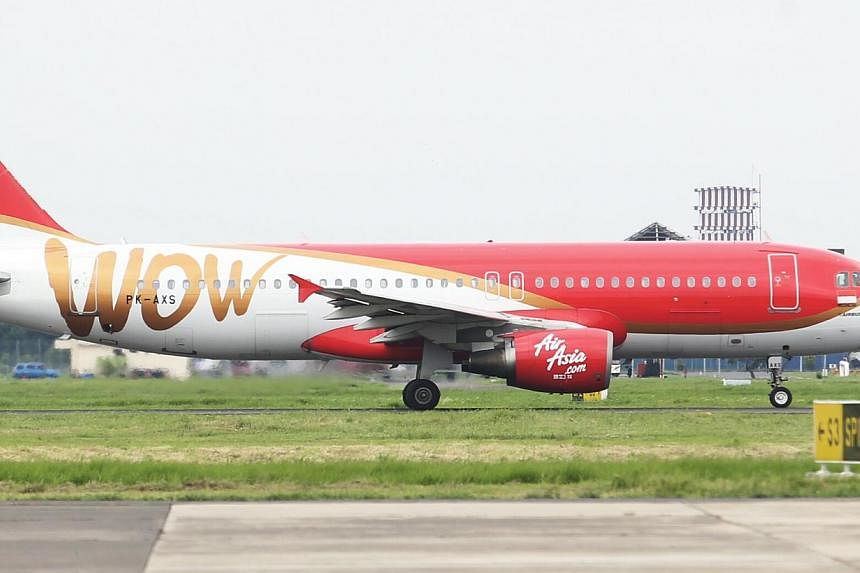 An AirAsia plane in Surabaya on Jan 3, 2015. Indonesia's transport ministry has ordered airport authorities to take action against staff who allowed Indonesia AirAsia to fly outside its approved schedule. -- PHOTO: SPH