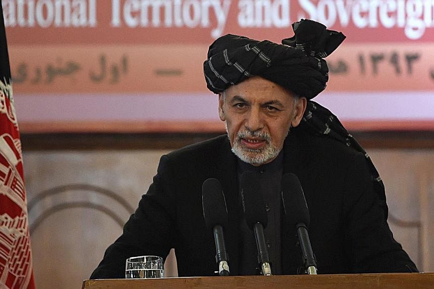 Afghan President Ashraf Ghani said in an interview broadcast on Sunday that the United States might want to "re-examine" the timetable for removing the remaining U.S-led coalition troops in the country by the end of 2016. -- PHOTO: AFP&nbsp;