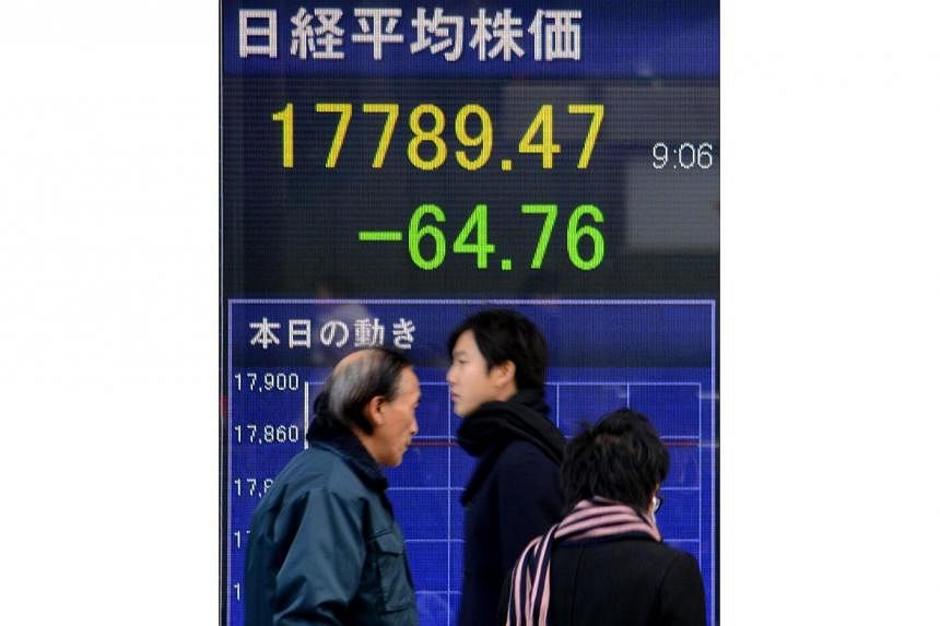 The Nikkei 225 index at the Tokyo Stock Exchange, which gained more than seven per cent in 2014, fell 125.09 points to 17,325.68 at the start. -- PHOTO: AFP&nbsp;