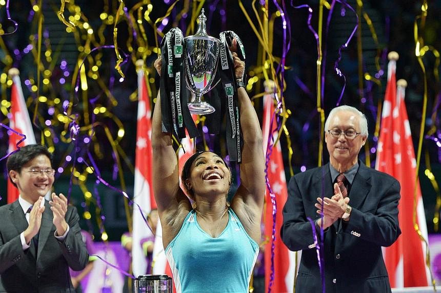 A jubilant Serena Williams after trouncing Simona Halep 6-3, 6-0 to secure the Billie Jean King trophy at the BNP Paribas WTA Finals Singapore, cheered on by Culture, Community and Youth Minister Lawrence Wong (left) and Emeritus Senior Minister Goh 