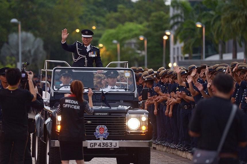 Outgoing Police Commissioner Ng Joo Hee waving to members of the police force during his farewell ceremony.&nbsp;-- ST PHOTO:&nbsp;DESMOND WEE