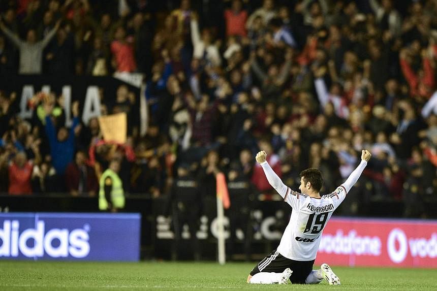 Valencia's defender Antonio Barragan Fernandez celebrates a goal by the club's Argentinian defender Nicolas Otamnedi during its Spanish league football match against Real Madrid at the Mestalla stadium on Sunday. -- PHOTO:AFP&nbsp;