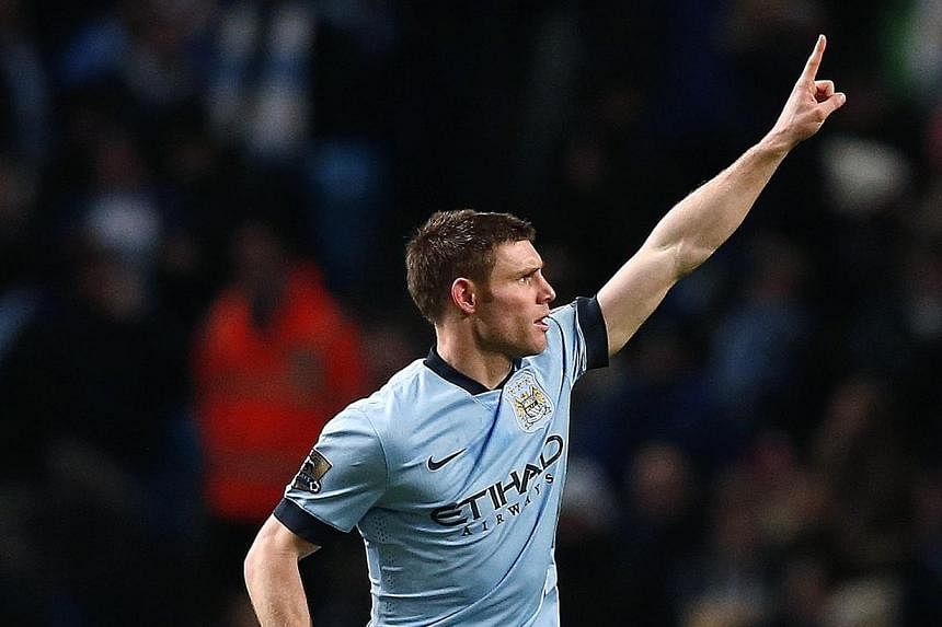 Manchester City's James Milner celebrates after scoring during their FA Cup third round soccer match against Sheffield Wednesday at the Etihad stadium in Manchester, England, on Sunday. -- PHOTO: REUTERS.