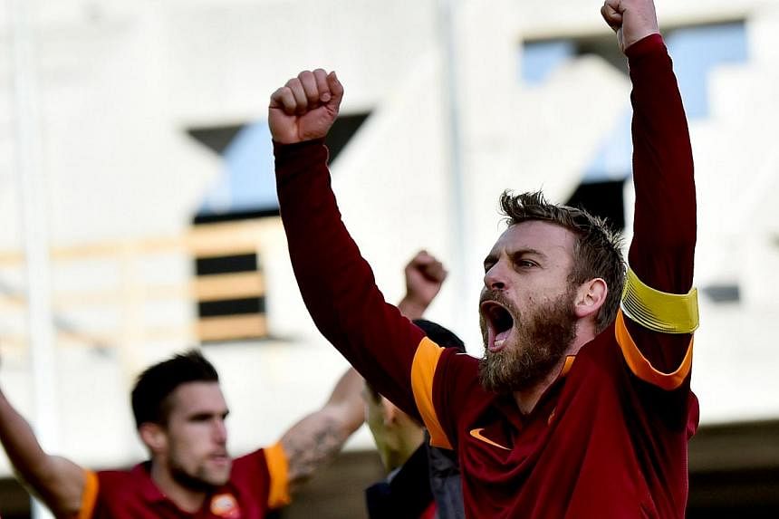 Roma's forward Daniele De Rossi celebrates at the end of the Italian Serie A football match between Udinese and AS Roma at Stadio Friuli in Udine on Jan 6, 2015. -- PHOTO: AFP