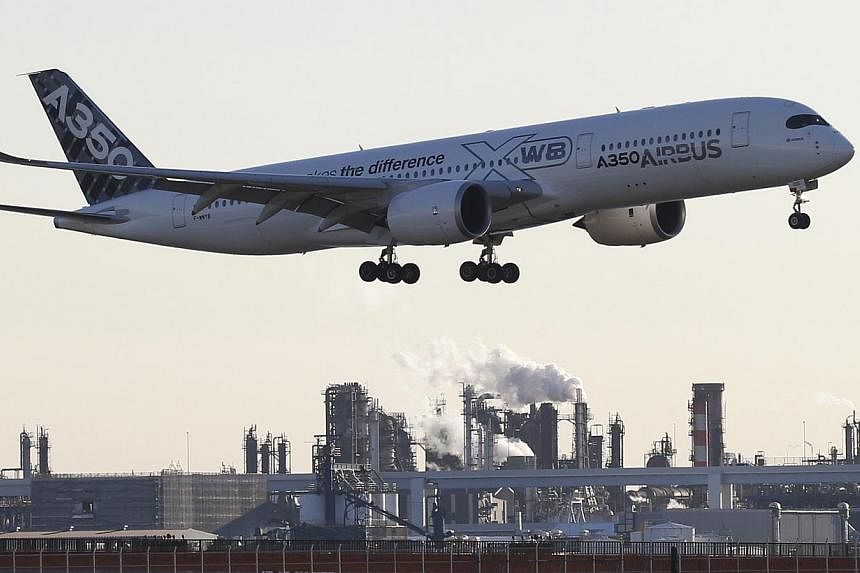An Airbus A350 XWB aircraft approaching to land at Haneda airport in Tokyo Nov 19, 2014.&nbsp;Airbus increased its deliveries in 2014, setting a new company record, a source at the European planemaker said on Tuesday. -- PHOTO: REUTERS