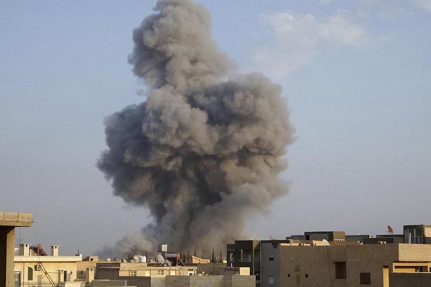 Smoke rising after a US-led air strike in Raqqa, eastern Syria, which is controlled by the Islamic State in Iraq and Syria (ISIS), on Oct 29, 2014. The US military is reviewing several incidents in which civilians may have been killed in coalition ai