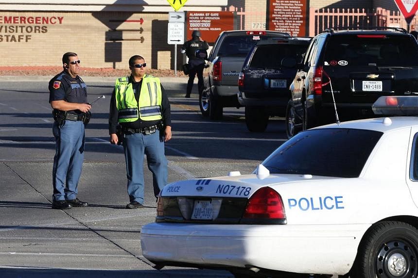 El Paso police blocking off an entrance to the Beaumont Army Medical Center as other officers search for the gunman during the shooting in El Paso, Texas, on Jan 6, 2015. -- PHOTO: REUTERS