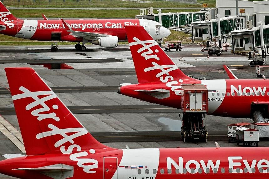 Three more weekly flights operated by Indonesia AirAsia to Singapore have been cancelled amid an official probe by the Indonesian authorities into the airline's flying permits. -- PHOTO: AFP