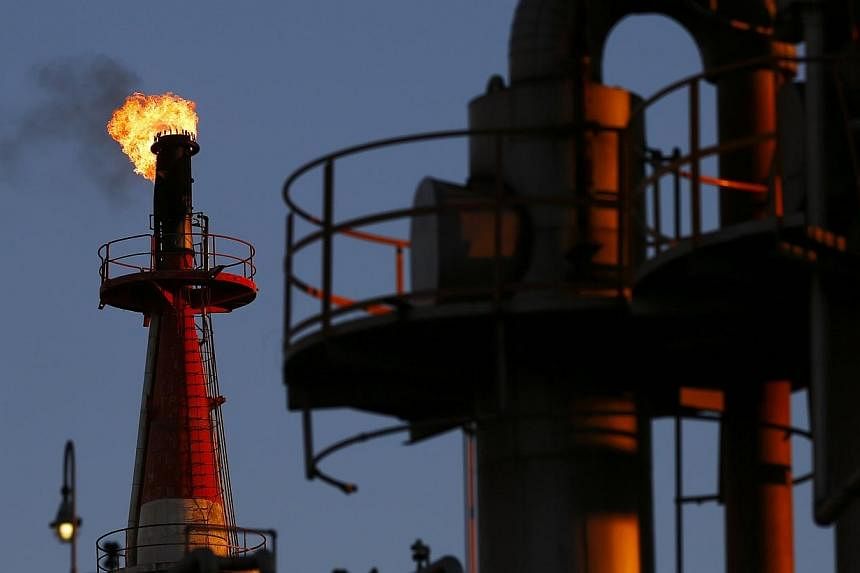 Oil prices will continue to drop as high production meets weak demand and a strong US dollar pressures crude, and markets will only pick up once major manufacturing economies particularly in Asia feel the benefit of cheaper energy. -- PHOTO: REUTERS
