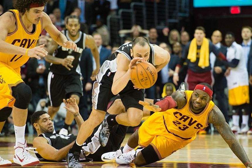 Manu Ginobili (#20) of the San Antonio Spurs steals the ball from LeBron James (#23) of the Cleveland Cavaliers during final seconds of the second half at Quicken Loans Arena on Nov 19, 2014 in Cleveland, Ohio. The Cavaliers are no longer favoured to