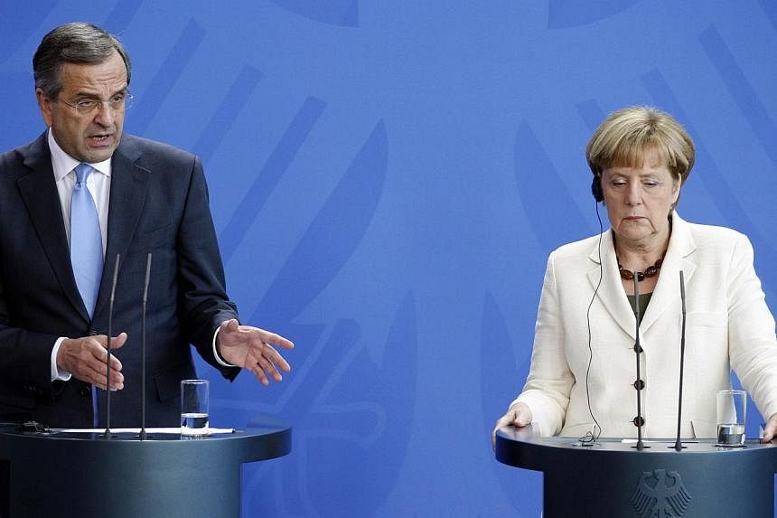 German Chancellor Angela Merkel (right) and Greek Prime Minister Antonis Samaras at a joint press conference at the chancellery in Berlin on Sept 23, 2014. -- PHOTO: AFP