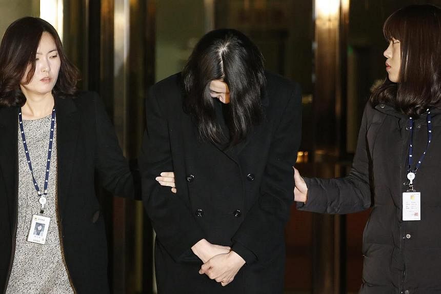 Cho Hyun Ah (centre), also known as Heather Cho, daughter of Korean Airlines chairman Cho Yang Ho, leaves for a detention facility after a Korean court ordered her to be detained, at the Seoul Western District Prosecutor’s office on Dec 30, 2014.&n