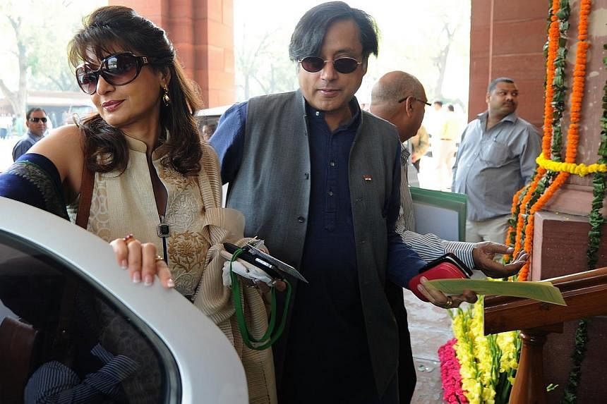 Former-junior minister for external affairs and Congress Party's Member of Parliament Shashi Tharoor (right) with his wife Sunanda Pushkar arrive at parliament for the opening of the budget session in New Delhi on March 12, 2012. -- PHOTO: AFP
