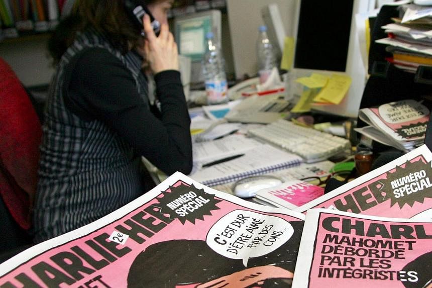 A journalist works in the Paris newsroom of French satirical weekly Charlie Hebdo, in this Feb 9, 2006, file photo. -- PHOTO: REUTERS