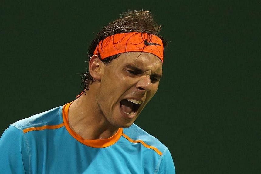 Spanish tennis player Rafael Nadal reacts after losing his tennis match against Michael Berrer of Germany in Qatar's ExxonMobil Open on Jan 6, 2015, in Doha. Berrer won the match 1-6, 6-3, 6-4. -- PHOTO: AFP&nbsp;