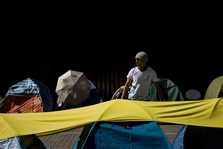 A pro-democracy supporter looking the last few tents allowed to remain outside the government building in Hong Kong on Jan 6, 2015. Hong Kong will take the next step in its contentious political reform process on Wednesday when the government unveils