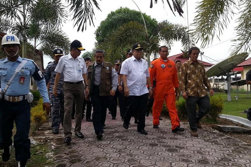The black box flight recorders of the AirAsia jet that crashed last month must be analysed in Indonesia, Minister for Maritime Affairs Indroyono Soesilo (right, in white) said on Wednesday, as Jakarta dispatched an unmanned underwater vehicle to reco