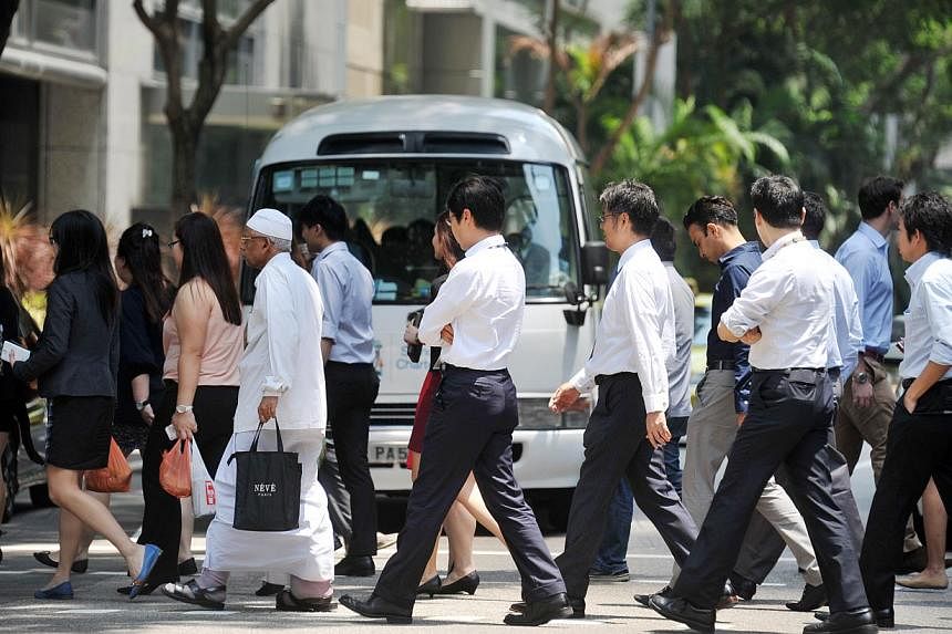 Office workers crossing the road at Market Street in Tanjong Pagar on Sept 8, 2014. -- PHOTO: ST FILE