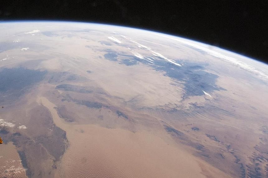 A view of a portion of the earth itself as seen from space in a Nasa photo taken in November last year from the International Space Station by the Expedition 42 crew shortly after sunrise. -- PHOTO: AFP