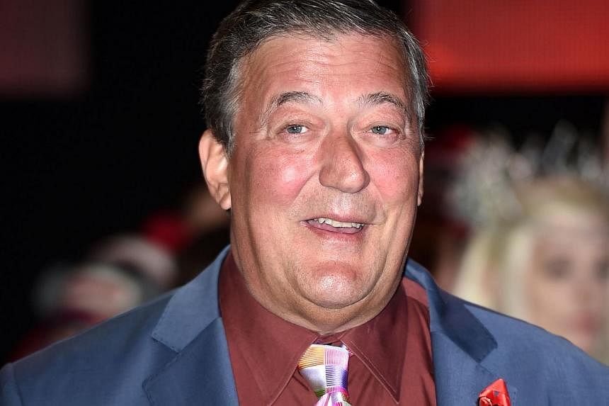 English actor Stephen Fry poses for pictures on the red carpet upon arrival for the world premier of The Hobbit: The Battle of the Five Armies in central London last month. -- PHOTO: AFP