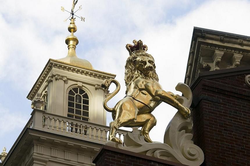 The newly-installed statue of a lion is seen on top of the Old State House in Boston, Massachusetts, in November last year. A time capsule was discovered in the head of the lion when it was removed for cleaning, and a new time capsule was placed in t
