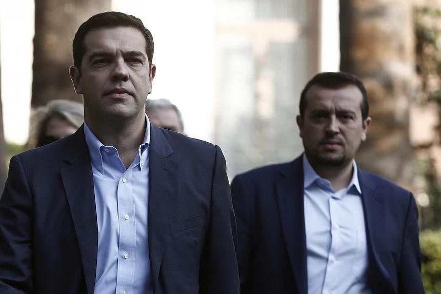 Alexis Tsipras (centre), leader of Greece's far-left Syriza party, leaves the Presidential palace in Athens in this file photo. The first sign of obvious trouble could come from Greece, where the populist left-leaning Syriza could win a snap election