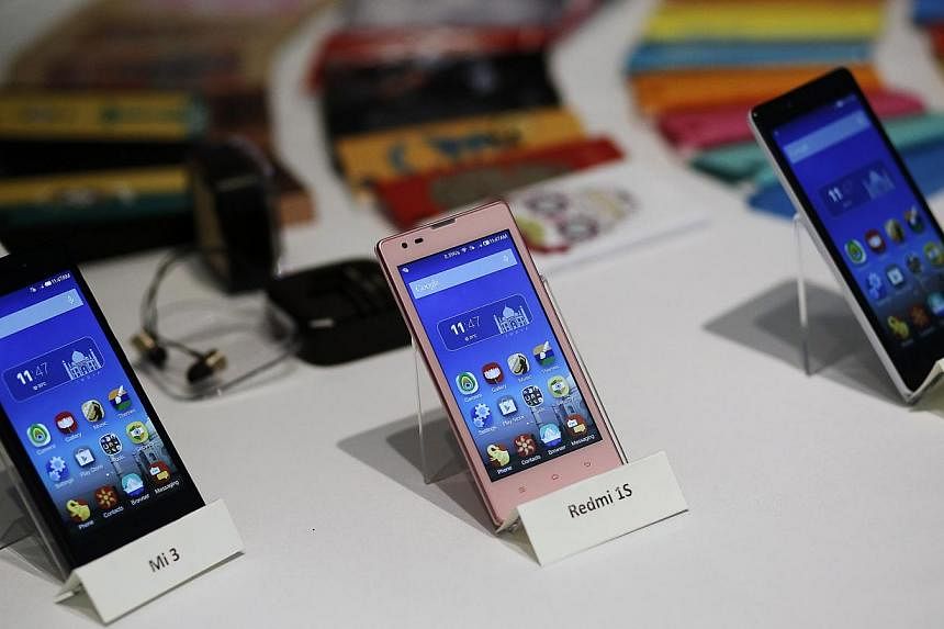 Three models of China's Xiaomi Mi phones during their launch in New Delhi. -- PHOTO: REUTERS
