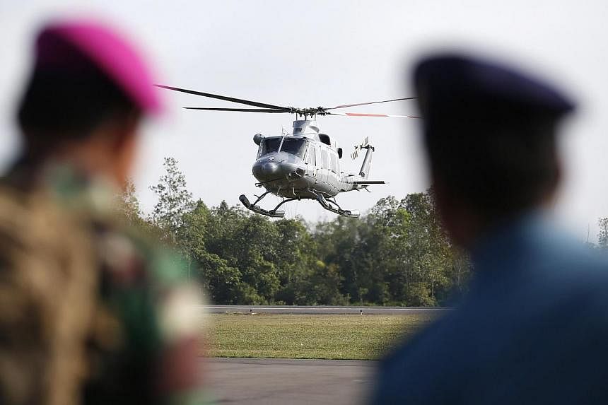An Indonesia Navy helicopter coming in to land at the air base where search and rescue operations for AirAsia flight QZ8501 are centred in Pangkalan Bun, central Kalimantan, on Jan 8, 2015. -- PHOTO: REUTERS