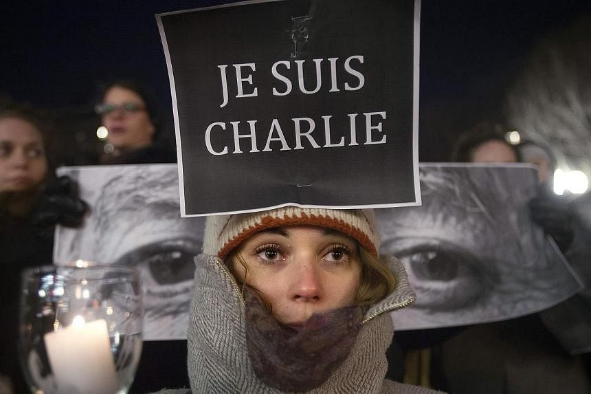 Amandine Marbach from Strasbourg, France, participating in a vigil to pay tribute to victims of an attack on satirical magazine Charlie Hebdo in Paris, in the Manhattan borough of New York on Jan 7, 2015. -- PHOTO: REUTERS&nbsp;