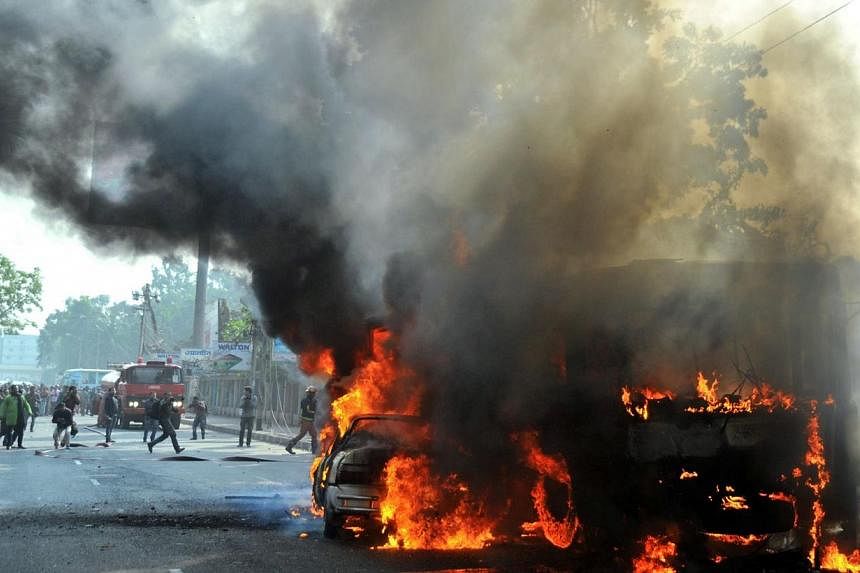 Burning vehicles, set on fire by opposition demonstrators, are pictured during violent protests in Dhaka on Jan 6, 2015.&nbsp;A political crisis in Bangladesh deepened on Thursday, after two more people died in a crackdown on anti-government proteste
