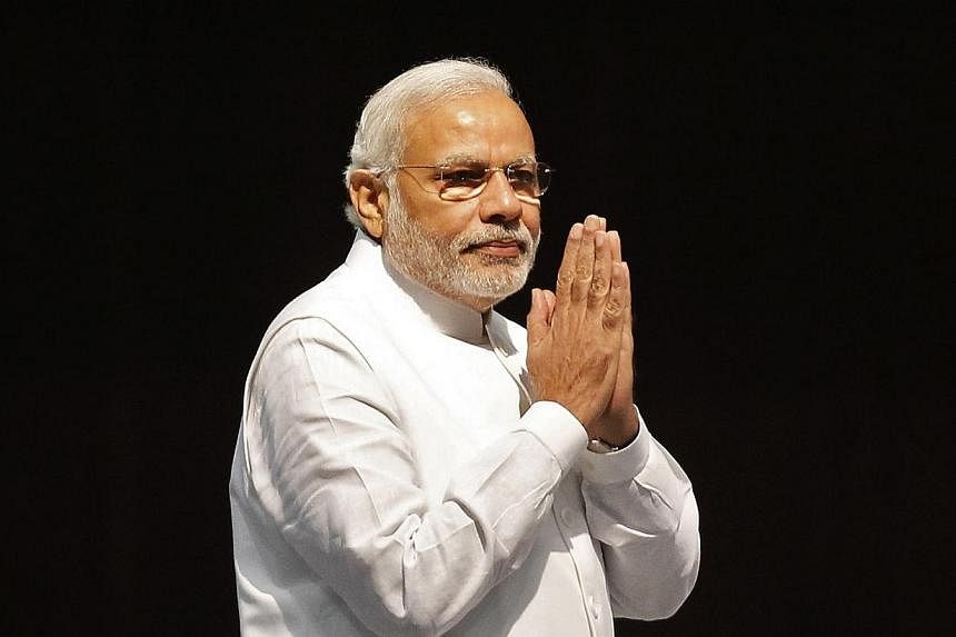 Indian Prime Minister Narendra Modi gestures upon his arrival at the inauguration ceremony of the thirteenth "Pravasi Bharatiya Divas" or Overseas Indians Conference at Gandhinagar in the western Indian state of Gujarat on Jan 8, 2015. -- PHOTO: REUT