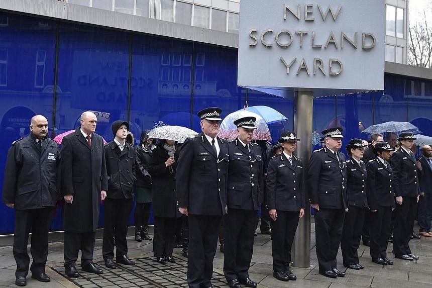 British police officers observe a two minute silence outside the Metropolitan Police headquarters, New Scotland Yard, in central London on Jan 8, 2015.&nbsp;Britain has increased security at some of its borders, including ports and rail entry points,